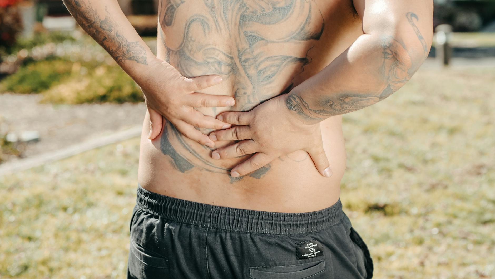 a man with tattoos on his back