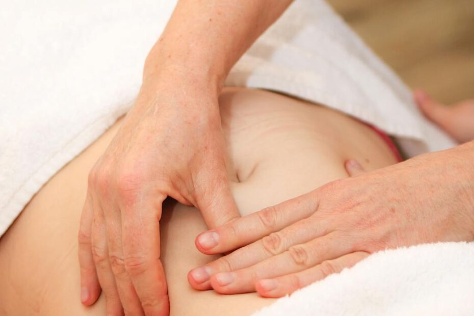 therapist performing abdominal massage therapy manual lymphatic drainage Huntington Beach